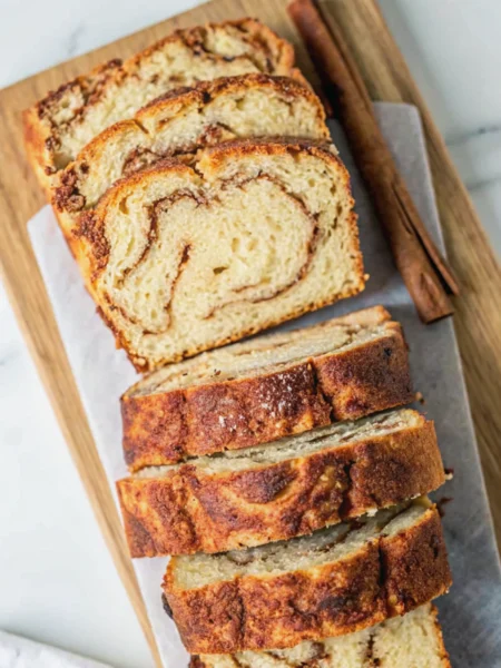 a loaf of cinnamon swirl bread no yeast on a cutting board